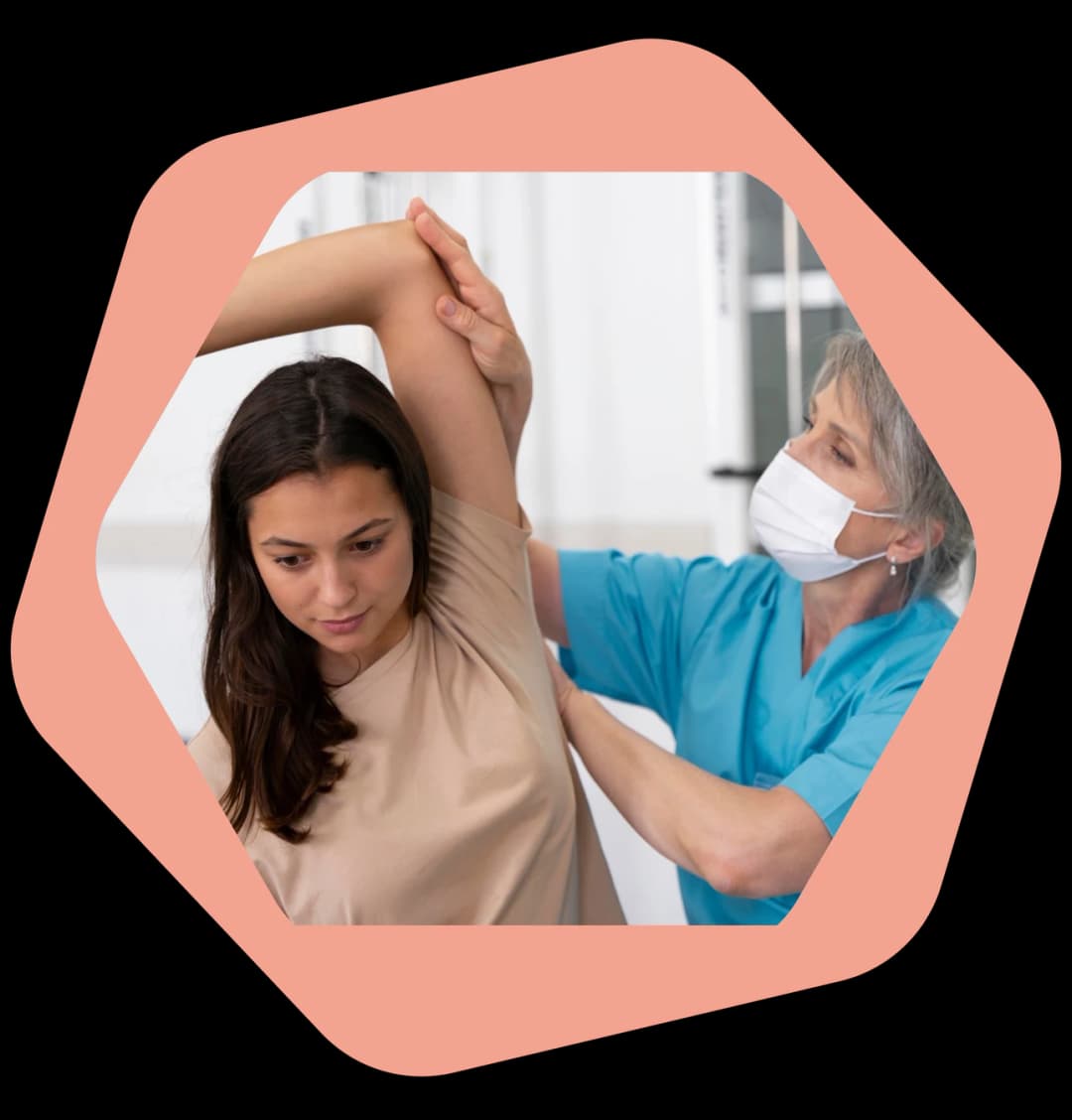 Physiotherapist treating a patient's shoulder during a home visit