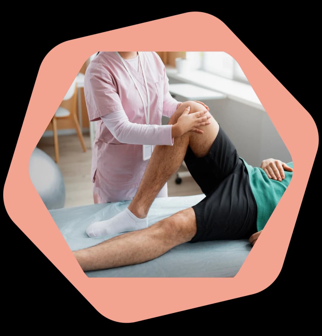Physiotherapist assessing a patient's knee during a home visit