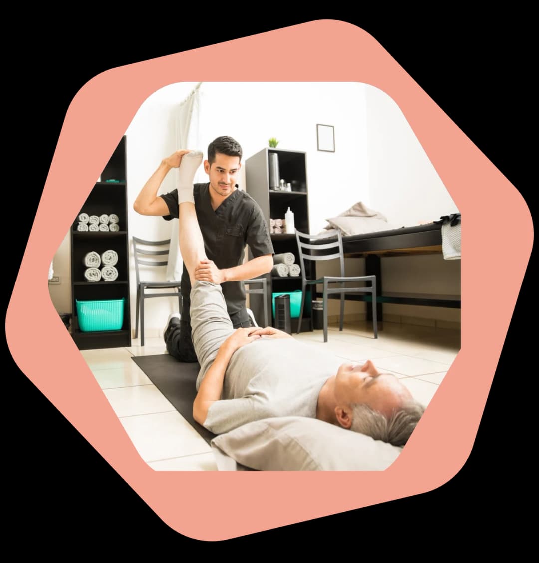 Physiotherapist guiding a patient through sciatic nerve glides during a home visit